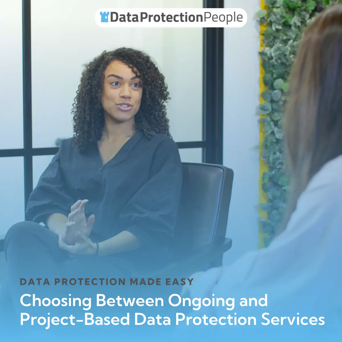 Woman speaking in a meeting about choosing data protection services, with visible text regarding the topic.